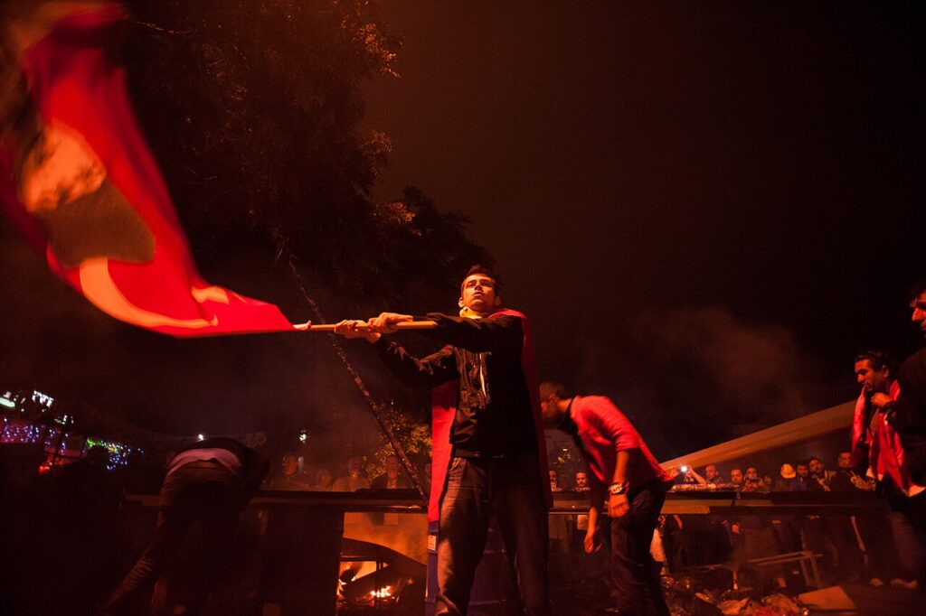 Nighttime protests in Ankara. Events of June 7-8, 2013. Young man waving a flag in darkness